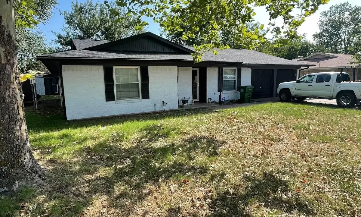 Professional roofing crew working on a residential roof in Northport